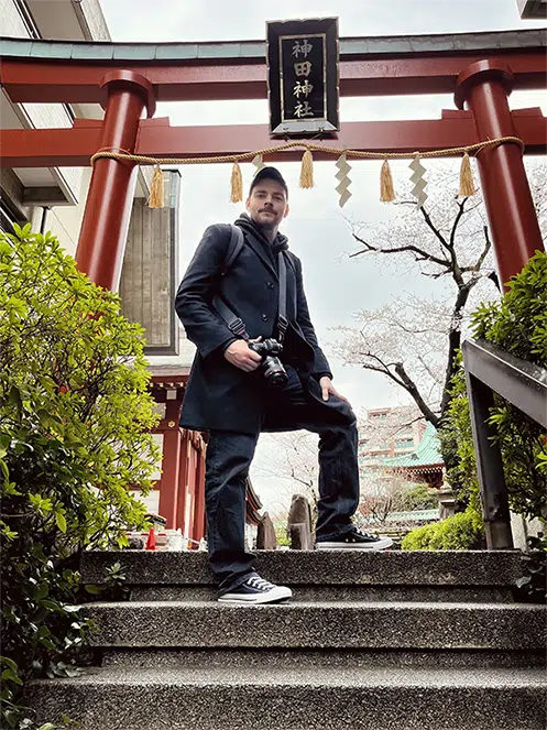 Jeremy Uni standing on top of temple stairs in Tokyo